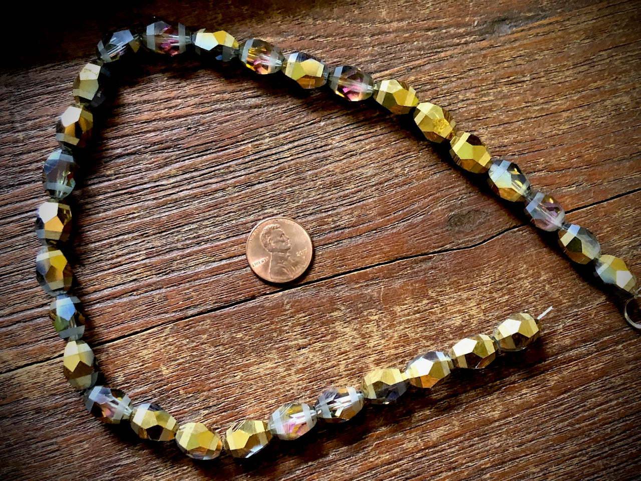 Crystal Orbits Faceted Rice Beads Strand - Smoke AB and Gold - 10mm x 13mm